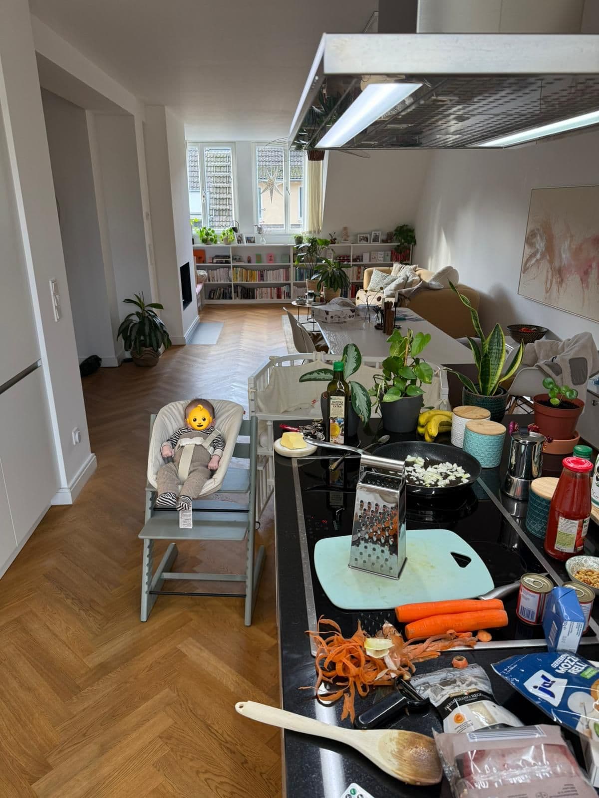 Family kitchen with meal preparation and a baby nearby